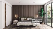 Interior of a modern luxury bedroom with garden view.